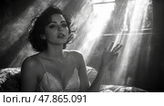 A woman in vintage clothing sits elegantly in a sunlit room, rays of light illuminating her contemplative expression and soft features. Стоковое AI-изображение, AI-художник Данила Большаков / Фотобанк Лори