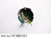 An electrical conduit box is built into the wall with wires sticking out as part of a home renovation. Стоковое фото, фотограф Виктория Тельминова / Фотобанк Лори