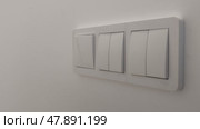 Triple switch on wall in house. Woman turns on light in apartment by pressing button with her finger. Concept of energy saving and economy. On and Off Light in room. Стоковое видео, видеограф Ирина / Фотобанк Лори