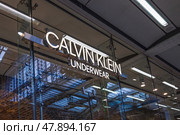 Calvin Klein Storefront with Illuminated Logo. London, UK, 25 February 2024. Редакционное фото, фотограф Zydrius Tartenis / Фотобанк Лори