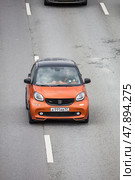 Smart ForTwo Brabus microcar manufactured by German multinational Daimler AG. City car moving on street at high speed. Редакционное фото, фотограф Константин Григорьев / Фотобанк Лори