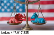 A balanced brass scales showcasing a red elephant and a blue donkey, symbols for the American Republican and Democrat parties, against a waving US flag background. Стоковое AI-видео, аниматор Михаил Строгалев / Фотобанк Лори