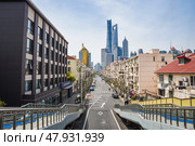 Shanghai, China - 1 April 2025: View of Lujiazui in Pudong with old housing and the Shanghai Tower, Jin Mao Tower and World Financial Center in the skyline. Редакционное фото, фотограф Татьяна Терехина / Фотобанк Лори