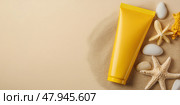 Yellow Sunscreen cream tube, starfishes and seashells on a sand top view. Cosmetic mockup. Sunblock lotion on sandy beach background. Summer vacation care concept, sun screen product, spf uv protect. Стоковое AI-изображение, AI-художник Марина Демидюк / Фотобанк Лори