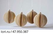 Honeycomb Paper Ornaments Hanging on a Christmas Tree. Paper Christmas Handmade foldable decor. Winter Creativity Crafts. Trendy Eco DIY. Modern Decoration. Boho Design. Structural 3d Origami Toy. Стоковое AI-видео, аниматор Марина Демидюк / Фотобанк Лори