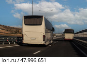 Tour Buses travel along road. Стоковое фото, фотограф Юрий Бизгаймер / Фотобанк Лори