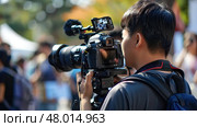 A photographer skillfully captures memorable moments at a lively outdoor event on a bright day. Стоковое AI-изображение, AI-художник Данила Большаков / Фотобанк Лори