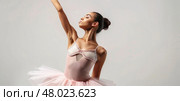 A ballet dancer showcases her skill and poise in a delicate pink tutu and elegant pose. Стоковое AI-изображение, AI-художник Данила Большаков / Фотобанк Лори