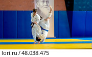 Moscow, Russia, April 24, 2025: Children practice martial arts with a coach in the gym, sambo, judo, aikido. Редакционное фото, фотограф Igor Skripachev / Фотобанк Лори