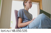 Teen girl school student wear headphones watching online webinar, talking through webcam looking at laptop. Teenager conducting video conference on computer at home, chatting online with friends. 4K. Стоковое видео, видеограф Марина Демидюк / Фотобанк Лори