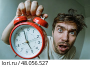 Man who just woke up with a alarm clock in his hand. Стоковое AI-изображение, AI-художник Дмитрий Киселёв / Фотобанк Лори