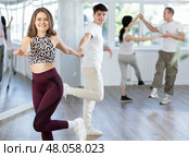 Girl paired up with young man, they train to perform disco fox dance, rehearse performance. Стоковое фото, фотограф Яков Филимонов / Фотобанк Лори