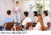 Young woman teacher conducting lesson with group of students. Стоковое фото, фотограф Яков Филимонов / Фотобанк Лори
