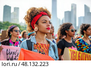 Young woman protesting for equal rights with a crowd of activists. Стоковое AI-изображение, AI-художник Юрий Поздников / Фотобанк Лори