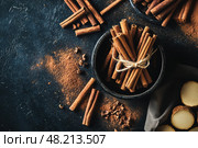 Cinnamon background. Pile of cinnamons stick top view. Cinnamomum cassia close up. Spice for the Holidays. Assortment of spices. Cinnamon bark is a spice used for sweet and savory dish. Стоковое AI-изображение, AI-художник Марина Демидюк / Фотобанк Лори