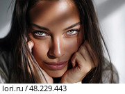 A woman with long brown hair and green eyes is looking at the camera. Стоковое AI-изображение, AI-художник Ярославский Максим / Фотобанк Лори