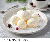 Cream balls served on a plate with a cup of coffee and powdered sugar on a light-colored table. Стоковое AI-изображение, AI-художник Natalia Akashkina / Фотобанк Лори