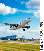 The take-off of a passenger plane, in the distance, the building of a modern airport. Стоковое AI-изображение, AI-художник Сергей Елизарьев / Фотобанк Лори
