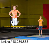 Teen girl jumping on trampoline on indoor inflatable playground. Стоковое фото, фотограф Яков Филимонов / Фотобанк Лори