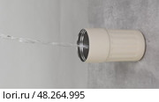 Water pouring into a beige thermos mug on a grey table. Стоковое видео, видеограф Катерина Белякина / Фотобанк Лори