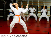 Woman in kimono standing in fight stance in gym. Стоковое фото, фотограф Яков Филимонов / Фотобанк Лори