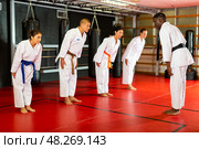 People in kimono bowing in front of karate trainer. Стоковое фото, фотограф Яков Филимонов / Фотобанк Лори