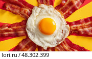 Fried Egg with Golden Yolk, Crispy Bacon Strips Framing the Perfect Breakfast. Жареное яйцо с золотистым желтком и хрустящие полоски бекона - идеальный завтрак. Стоковое AI-изображение, AI-художник Katsiaryna Repich / Фотобанк Лори