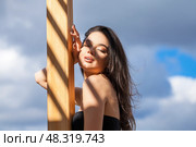 Young beautiful woman on a background of blue sky. Стоковое фото, фотограф Андрей Аркуша / Фотобанк Лори