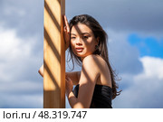 Young beautiful woman on a background of blue sky. Стоковое фото, фотограф Андрей Аркуша / Фотобанк Лори