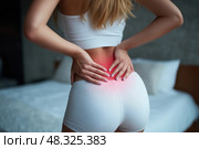 Back pain, kidney inflammation, woman suffering from backache at home. Стоковое AI-изображение, AI-художник Станислав Тарко / Фотобанк Лори