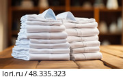 elegance white shirts stacked ai generated. Стоковое AI-изображение, AI-художник Vectorwin / Фотобанк Лори