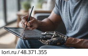 Man with bionic arm drawing on tablet. Стоковое AI-видео, аниматор Юрий Поздников / Фотобанк Лори