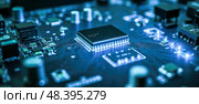 Microchip technology background with blue circuit board, digital pathways, electronic design, glowing elements, modern innovation, and high-tech integrated circuit. Стоковое фото, фотограф Павел Муравьев / Фотобанк Лори