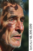 A close-up of an old man's face streaked with tears as he listens to a lamentation song, the shadows of tree branches dancing across his features. Стоковое AI-видео, аниматор Sergey Grishin / Фотобанк Лори