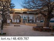 View of the courtyard of the Bahauddin Naqshbandi Memorial Complex with a pond in the foreground on a sunny day, Bukhara, Uzbekistan. Стоковое фото, фотограф Ula Ulachka / Фотобанк Лори