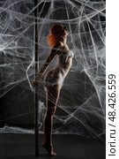 Red woman captured in a web of netting during an artistic performance. Стоковое фото, фотограф Гурьянов Андрей / Фотобанк Лори