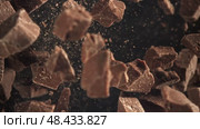 Pieces of chocolate fly up and fall down. Filmed on a high-speed camera at 1000 fps. Стоковое видео, видеограф Артем Шадрин / Фотобанк Лори