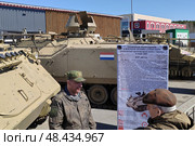 Пожилой человек общается с ветераном. Выставка трофейной военной техники в парке ЦПКиО им. В. В. Маяковского, Екатеринбург. На фоне БТР иностранного производства. Редакционное фото, фотограф Vladislav_v / Фотобанк Лори
