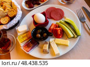 Turkish halal breakfast with cheese, sausages, eggs, vegetables, olives. Стоковое фото, фотограф Яков Филимонов / Фотобанк Лори