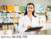 Woman pharmacist makes restock, uses electronic carrier tablet of information. Стоковое фото, фотограф Яков Филимонов / Фотобанк Лори