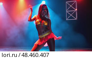 A woman in a bright costume dancing under light effects, front view, bright lighting, energetic color palette with neons and black. Стоковое AI-видео, аниматор Sergey Grishin / Фотобанк Лори