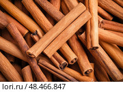 Cinnamon background. Pile of cinnamons stick top view. Cinnamomum cassia close up. Spice for the Holidays. Assortment of spices. Cinnamon bark is a spice used for sweet and savory dish. Стоковое AI-изображение, AI-художник Марина Демидюк / Фотобанк Лори