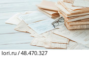 Vintage Epistolary Legacy: a Timeless collection of manuscripts with spectacles. Стоковое AI-изображение, AI-художник Данила Большаков / Фотобанк Лори