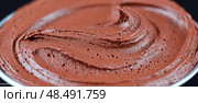 A brown frosting swirls on a plate. Стоковое AI-изображение, AI-художник Ярославский Максим / Фотобанк Лори