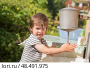 Cute boy washes his hands under washstand. Стоковое фото, фотограф Юлия Бабкина / Фотобанк Лори