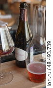 Russia, St.Petersburg, 24 April 2025: bottle of champagne is cooled in a niche with ice in the restaurant, local lighting, wine cabinet, decanters for sparkling wine. Редакционное видео, видеограф Vladimir Drozdin / Фотобанк Лори
