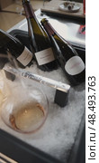 Russia, St.Petersburg, 24 April 2025: Several bottles of champagne brand Bonnet-Ponson are cooled in a niche with ice in the restaurant, local lighting, wine cabinet, decanters for sparkling wine. Редакционное видео, видеограф Vladimir Drozdin / Фотобанк Лори