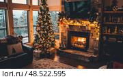 A cozy living room filled with various furniture pieces and a crackling fireplace. Стоковое AI-изображение, AI-художник Данила Большаков / Фотобанк Лори