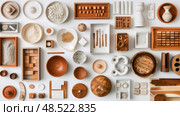 Various types of pottery displayed on a table, ranging from vases and bowls to mugs and plates, showcasing different colors, shapes, and textures. Стоковое AI-изображение, AI-художник Данила Большаков / Фотобанк Лори