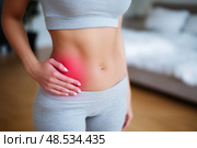 Inflammation of appendicitis, menstrual pain, woman with stomachache suffering from pms at home, endometriosis, cystitis and other diseases of the urinary system. Стоковое AI-изображение, AI-художник Станислав Тарко / Фотобанк Лори